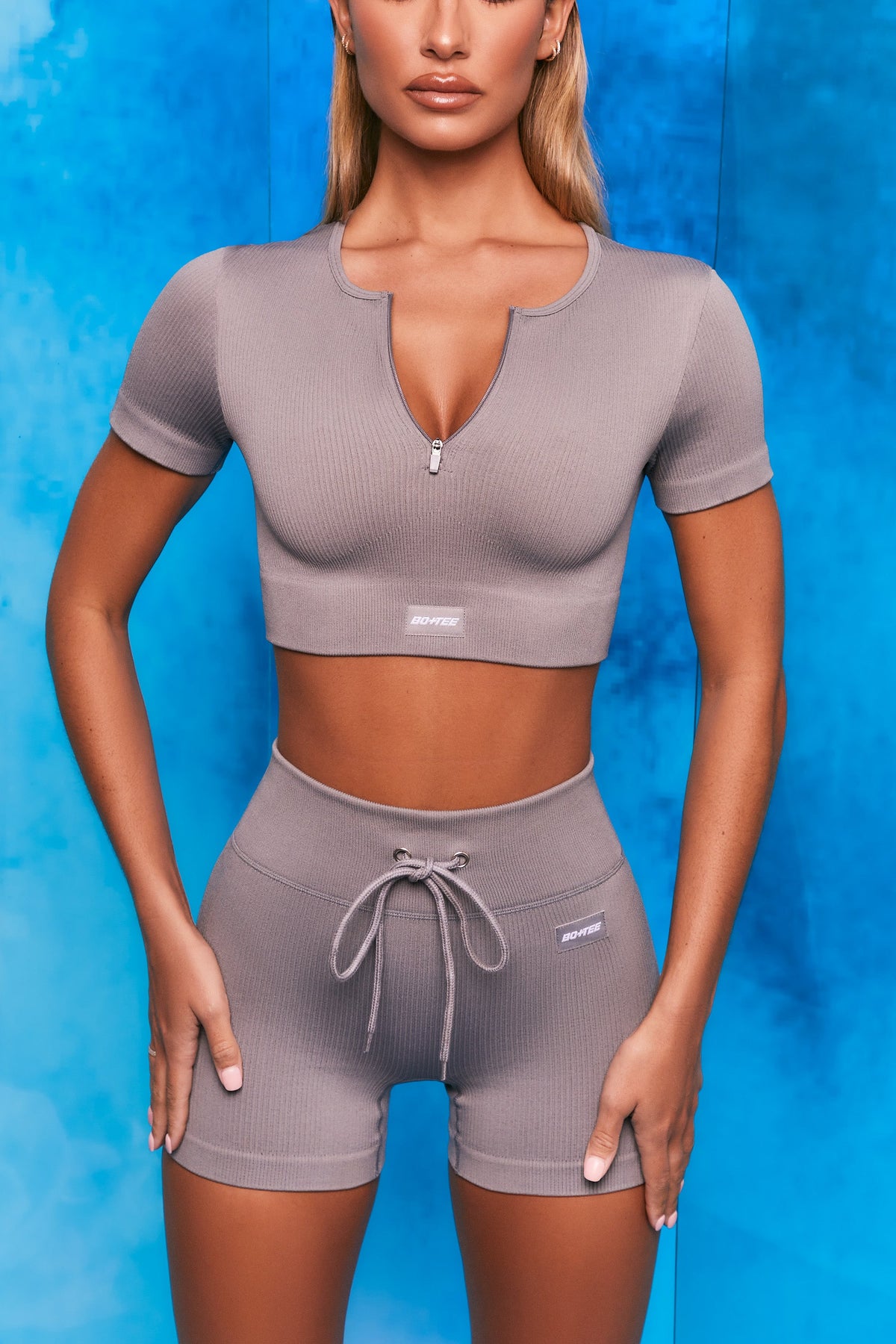 Perform Ribbed Short Sleeve Zip Front Crop Top in Dark Grey